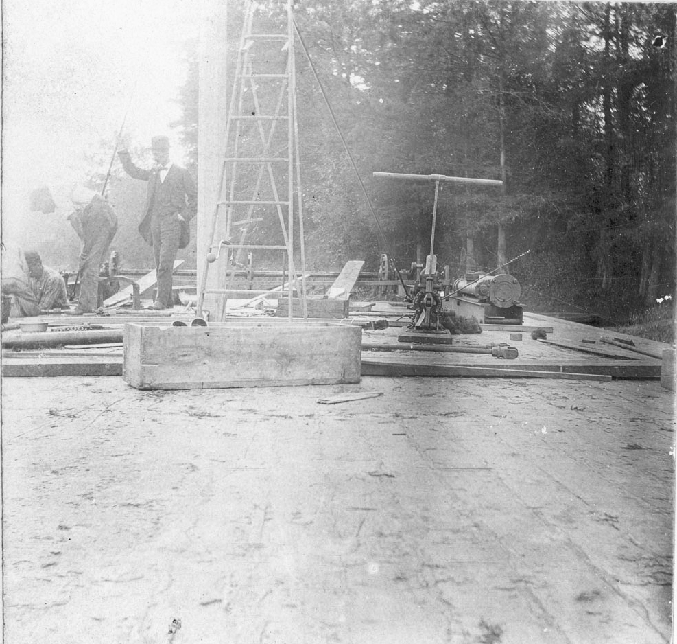 The steamer Tarboro under construction.  Visible from left:
several men working, one supervising, a mast, a ladder, a hand pump,
and a steam engine.